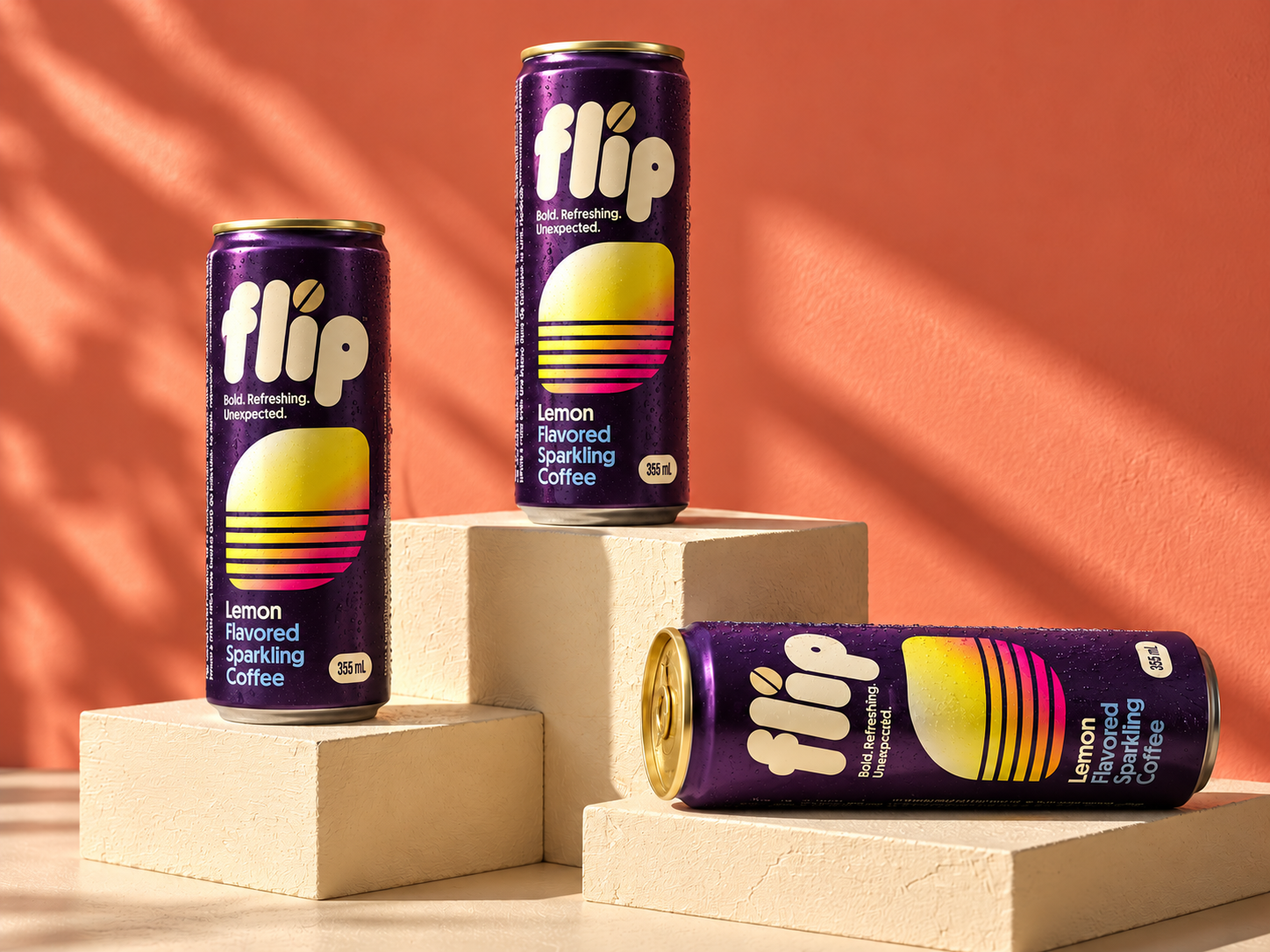 Campaign imagery: three purple FLIP Lemon cans on cream plinths against a coral studio background